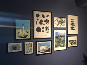 Photos hanging on a Farrow and Ball blue painted wall