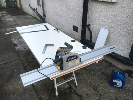Titan track saw, plunge saw cutting a timber door down to size